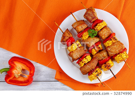 grilled pork meat with pieces of corn cobs grilled pork meat with pieces of corn cobs 32874990