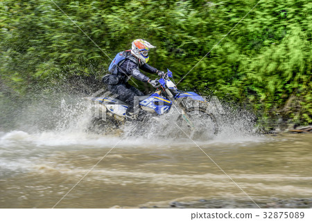 motorcycle Enduro river in a shallow place of the 32875089