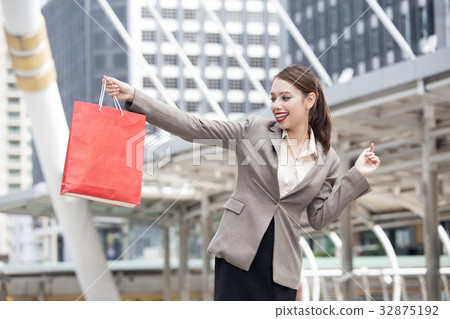 woman holding red shopping bag 32875192
