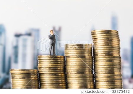 miniature model of investor standing on coin miniature model of investor standing on coin 32875422