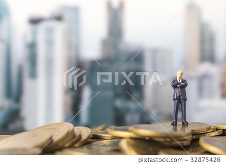 miniature model of investor standing on coin miniature model of investor standing on coin 32875426
