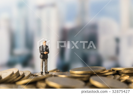 miniature model of investor standing on coin miniature model of investor standing on coin 32875427