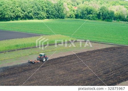 Tractor plowing field 32875967