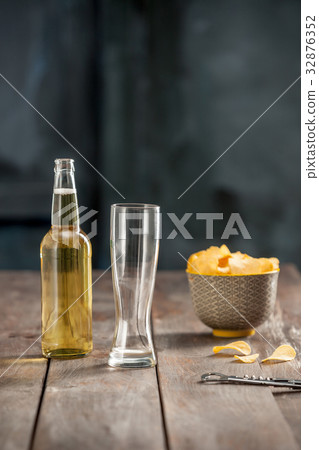 Beer glass and potato chips, pistachios isolated Beer glass and potato chips, pistachios isolated 32876352