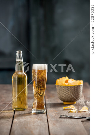Beer glass and potato chips, pistachios isolated Beer glass and potato chips, pistachios isolated 32876353