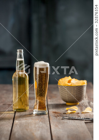 Beer glass and potato chips, pistachios isolated Beer glass and potato chips, pistachios isolated 32876354