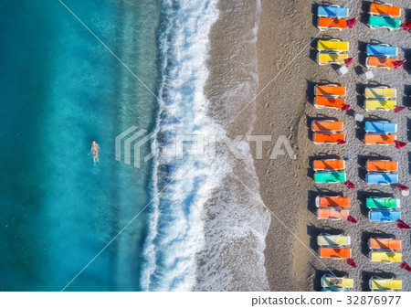 Aerial view of swimming woman in the sea Aerial view of swimming woman in the sea 32876977