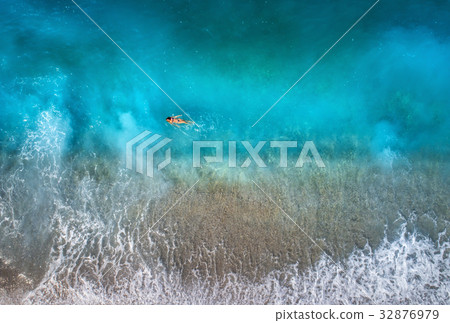Aerial view of swimming woman in mediterranean sea Aerial view of swimming woman in mediterranean sea 32876979