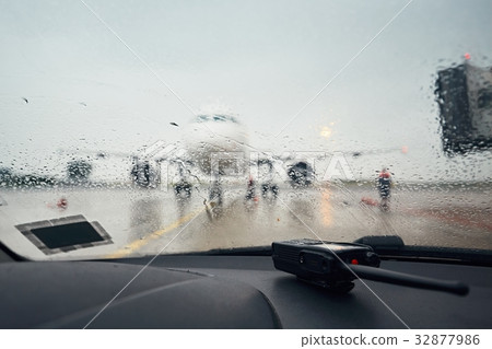 A busy airport in the rain 32877986