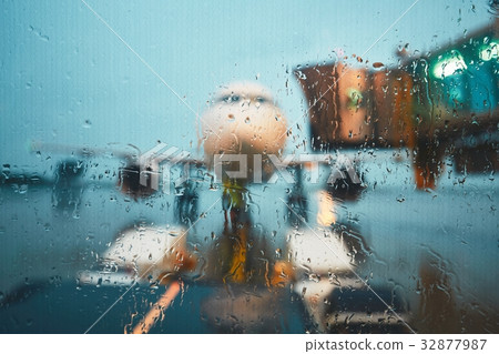 A busy airport in the rain A busy airport in the rain 32877987