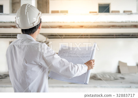 Engineer checking architectural drawing Engineer checking architectural drawing 32883717