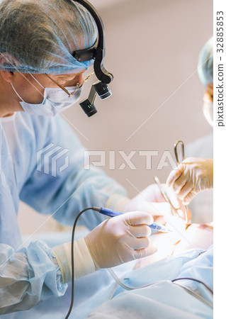 Surgeons team working with Monitoring of patient in surgical operating room. breast augmentation 32885853