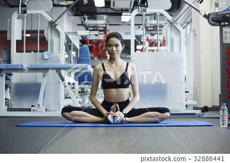 A young woman is practising meditation at a fitness room 32886441