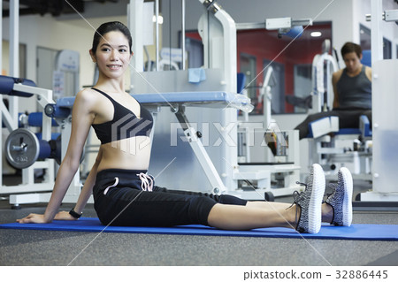 A woman in sportswear is doing yoga 32886445