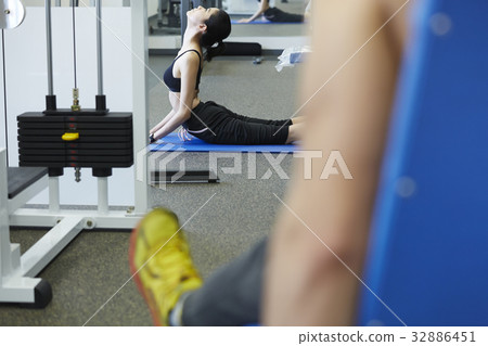 A picture of a girl stretching at a fitness centre 32886451