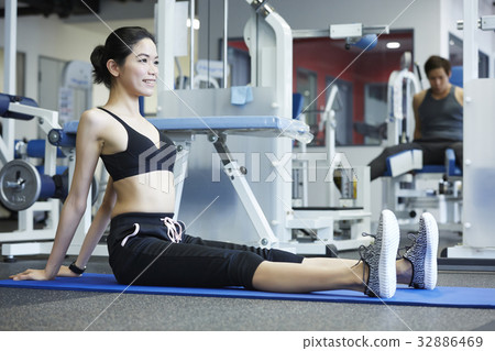 A portrait of a pretty girl with a smile sitting at fitness club 32886469