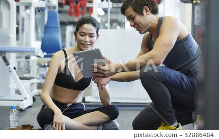A coach is training for a girl with a tablet A coach is training for a girl with a tablet 32886484