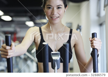 Woman is doing exercises with modern equipment to lose weight 32886579