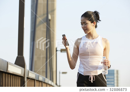 a picture of a girl looking at her phone and holding a bottle a picture of a girl looking at her phone and holding a bottle 32886873