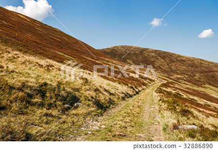 road through mountains with reddish hills road through mountains with reddish hills 32886890