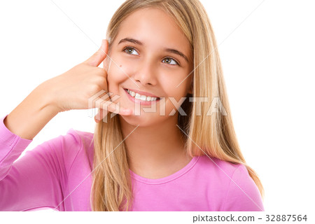 Portrait of young girl taking a call me gesture Portrait of young girl taking a call me gesture 32887564