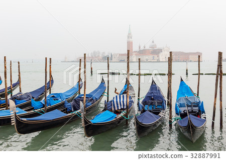 Gondola moored at dock in Venice. 32887991