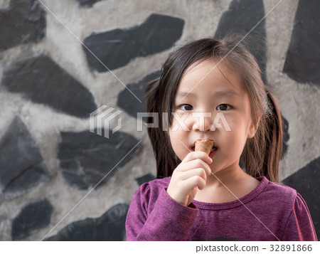 Little Asian girl eating ice cream 32891866