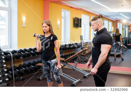 Working out in gym: Beutiful yong woman doing 32892066