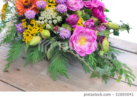 bouquet of different flowers on wooden background 32893041