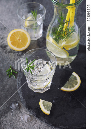 Detox water, lemonade with ice, lemon and rosemary 32894393