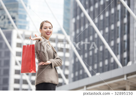 woman holding red shopping bag 32895150