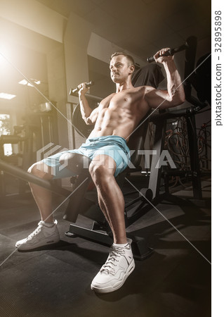 handsome fitness man weightlifting workout in gym 32895898
