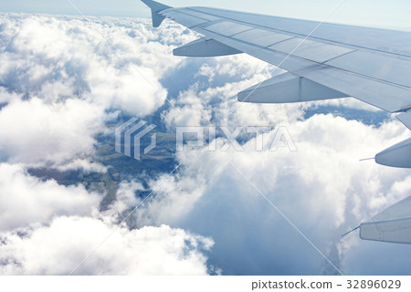 Clouds under the wing of an airplane 32896029