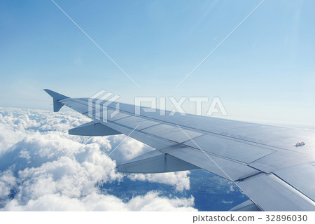 Clouds under the wing of an airplane Clouds under the wing of an airplane 32896030