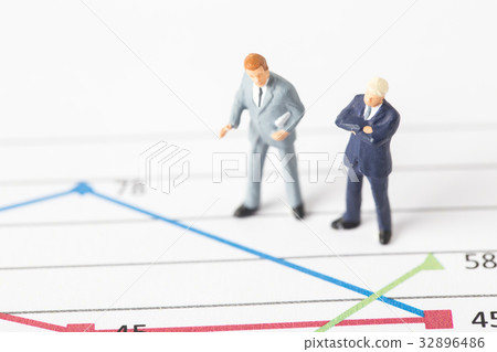Miniature model of businessman standing on chart Miniature model of businessman standing on chart 32896486