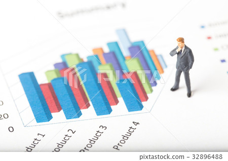 Miniature model of businessman standing on chart 32896488