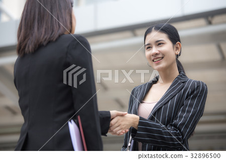 Asian businesspeople shaking hands each other. Asian businesspeople shaking hands each other. 32896500