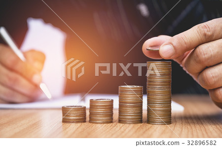 Saving money concept and hand putting money 32896582