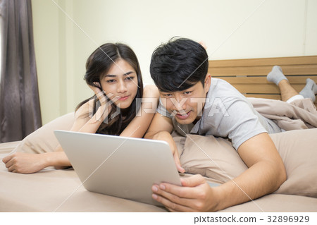 Asian couple man and woman using computer Asian couple man and woman using computer 32896929