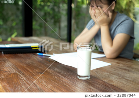 Teenage hand cover her face frustrated do homework Teenage hand cover her face frustrated do homework 32897044