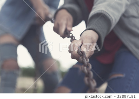 Team pulling chain, teamwork togetherness concept. 32897181