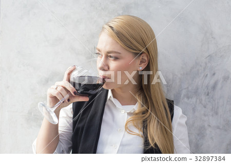 Portrait of a beautiful young woman reading book 32897384