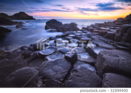 sunset over rocks formation Giants Causeway 32899400