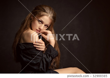 Portrait of a woman with a sensitive look Portrait of a woman with a sensitive look 32900385