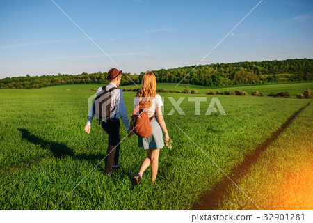 With a backpack, a man in a hat and a woman With a backpack, a man in a hat and a woman 32901281