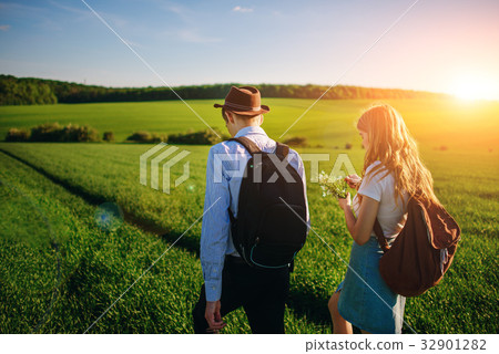 With a backpack, a man in a hat and a woman With a backpack, a man in a hat and a woman 32901282