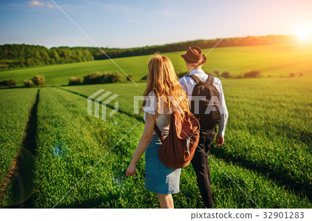 With a backpack, a man in a hat and a woman With a backpack, a man in a hat and a woman 32901283