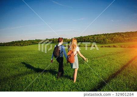 With a backpack, a man in a hat and a woman With a backpack, a man in a hat and a woman 32901284