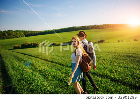 With a backpack, a man in a hat and a woman With a backpack, a man in a hat and a woman 32901289