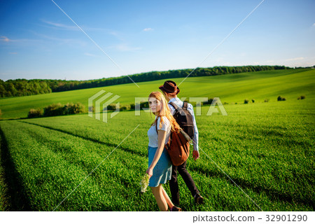 With a backpack, a man in a hat and a woman With a backpack, a man in a hat and a woman 32901290